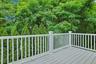 Enjoy peaceful views of mature trees and lush greenery from the private Trex deck—an ideal extension of the home's living space and built for years of