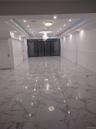 Spare room with a raised ceiling, light marble finish flooring, and recessed lighting
