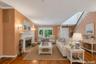 Living room has beautiful polished hardwood floors and crown molding throughout window treatment stay