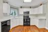 Eat in Kitchen -Formica cabinets and countertop. Hardwood floors