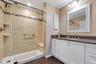 Master bedroom bathroom, tiled  shower area w bench seat , and floors. Granite countertop.