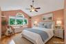 Master bedroom Suite,  polished hardwood floors and vaulted ceilings. Light and bright window treatments stay. ceiling fan.