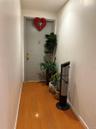 Hallway with hardwood / wood-style flooring