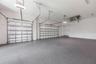 Oversized 3-car garage with industrial-grade epoxy flooring, Wi-Fi garage door openers, and impressive 11-foot ceilings.