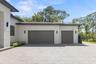 Modern paver driveway with turnaround area and additional parking space.