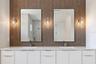 The luxurious primary suite offers a spa-inspired retreat featuring a freestanding soaking tub, oversized walk-in shower with rain head and handheld s