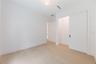 Spacious bedroom 3 with impact-rated window, solid-core door, and convenient access to a full bath.