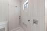 The luxurious primary suite offers a spa-inspired retreat featuring a freestanding soaking tub, oversized walk-in shower with rain head and handheld s