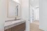 The 2nd full bathroom showcases oversized Italian tile, designer-selected fixtures, and elegant finishes consistent with the home's custom craftsmansh