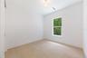 Spacious bedroom 3 with impact-rated window, solid-core door, and convenient access to a full bath.