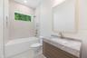 The 2nd full bathroom showcases oversized Italian tile, designer-selected fixtures, and elegant finishes consistent with the home's custom craftsmansh