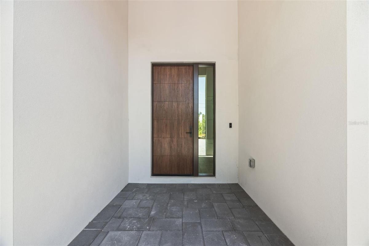 Premium Mastergrain Cherry fiberglass entry door with:Multipoint locking system, impact-rated Low-E sidelight,EMTEK designer hardware,realistic woodgr