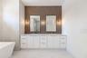 The luxurious primary suite offers a spa-inspired retreat featuring a freestanding soaking tub, oversized walk-in shower with rain head and handheld s
