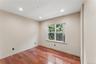 Bedroom featuring wood-finish flooring, recessed lighting, neutral wall tones, and a multi-pane window with blinds