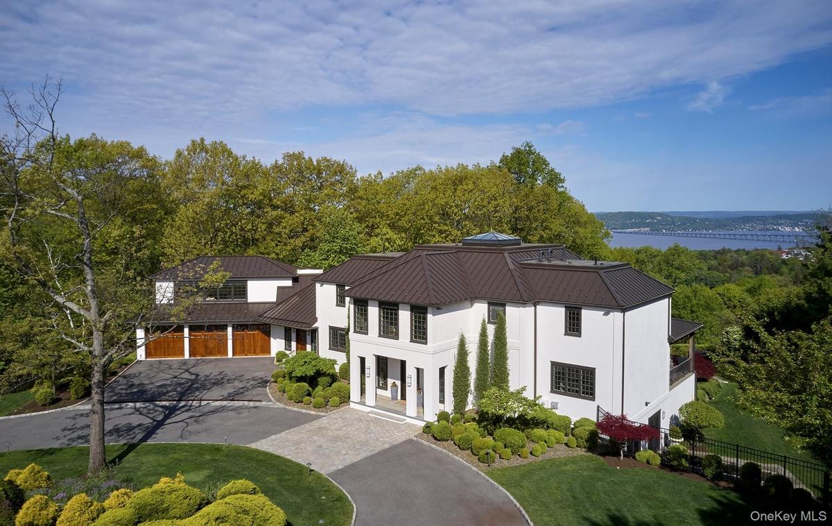 Magnificently set on 1.5 acres surrounded by lush lawns and beautiful perennial landscaping.