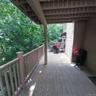 Expansive wood-finish deck with a solid railing, offering an elevated outdoor living area