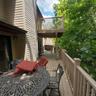 Spacious outdoor deck featuring wood-finish flooring, a full railing system, and direct exterior access