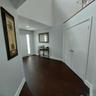Entryway featuring dark wood-finish flooring, white baseboards, and light gray walls