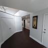 Entryway featuring dark wood-finish flooring, white baseboards, and light gray walls