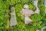 From above, the home's unique design is beautifully integrated into its lush natural surroundings.
