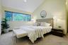 One of three generously sized bedrooms in the kids' wing, offering peaceful treetop views and ample closet space.