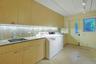 The expansive laundry and utility room provides abundant storage, workspace, and convenient access to the driveway and parking court.