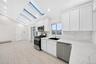 Kitchen with high ceiling and skylights