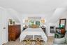 2nd floor Primary Bedroom featuring light wood-finish flooring, white walls, and a window with a roman shade