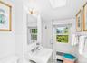 Bathroom featuring wainscoting and a pedestal sink with chrome fixtures