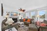 Bright living room with coastal décor, large windows, and abundant natural light.