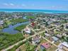 Elevated drone view showing the home's proximity to waterways and the Gulf Coast.