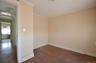 Bedroom featuring hardwood flooring, light-toned walls, white trim, and a ceiling light fixture