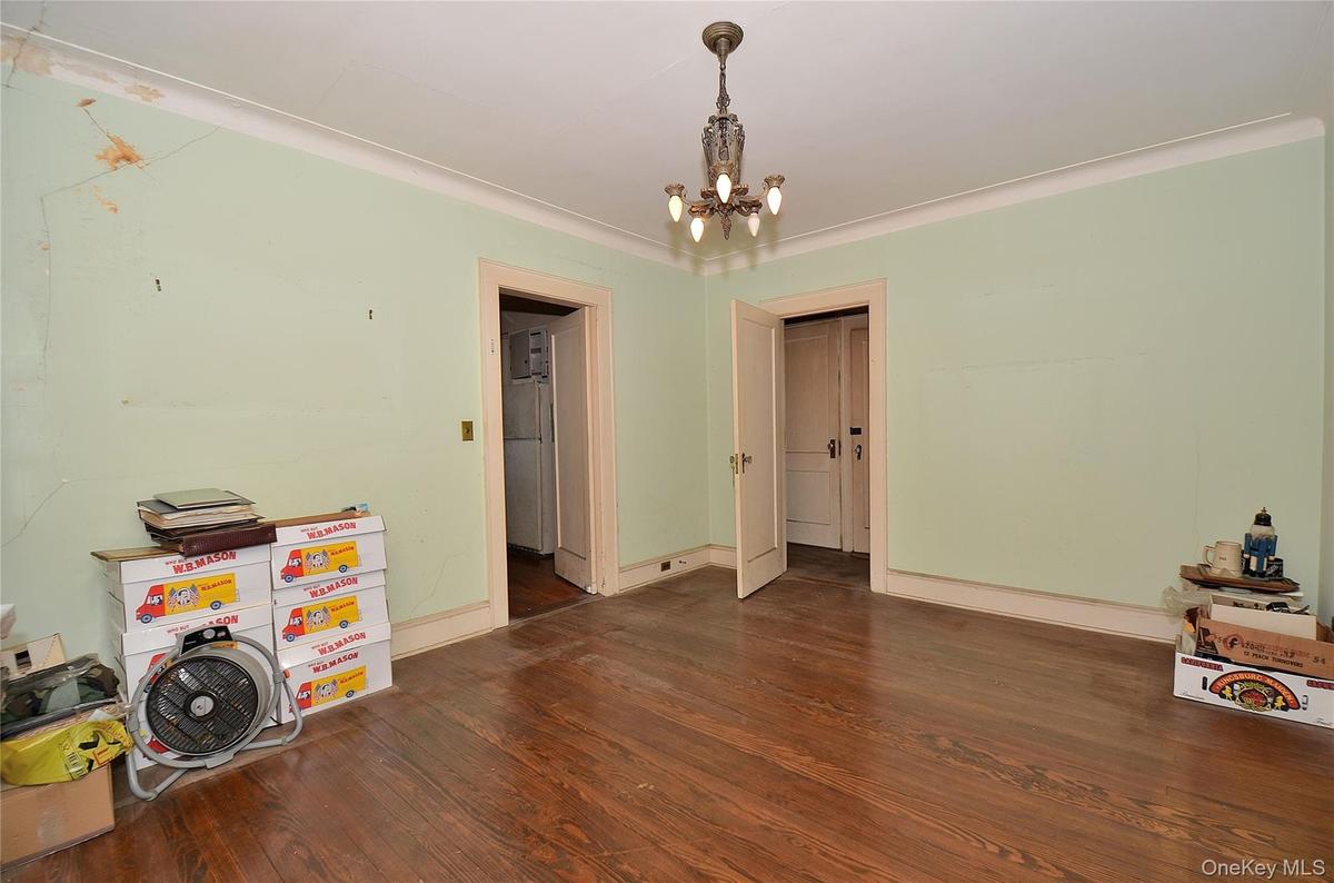 Dining Room featuring a solid wood door, hardwood flooring, and crown molding