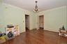 Dining Room featuring a solid wood door, hardwood flooring, and crown molding