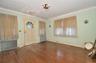 Living Room featuring a solid wood door, hardwood flooring, and crown molding