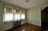 Bedroom featuring wood-finish flooring, a baseboard radiator, and light green wall paint