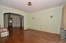 Living Room featuring a solid wood door, hardwood flooring, and crown molding