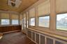 Sunroom featuring wood-paneled walls, wood-finish flooring, and a wood-plank ceiling