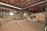 Spacious unfinished basement featuring exposed wood joists and concrete flooring