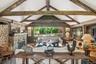 Living room offers views of swimming pond, stream