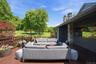 Large deck off main floor of primary home with views of stream and pond