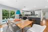 Open-concept kitchen and dining area featuring a two-toned cabinetry design