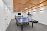 Recreation room featuring a paneled wood ceiling with recessed lighting and wall sconces