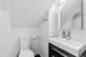 Modern bathroom featuring a contemporary vanity with an integrated sink, chrome faucet, and a wall-mounted mirror