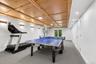 Recreation room featuring a wood-panel ceiling, recessed lighting, and wall sconces