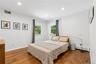 Bedroom featuring wood-finish flooring, recessed lighting, and two windows with exterior views