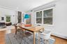 Spacious dining area with wood-finish flooring and two large windows