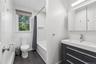 Bathroom featuring a modern vanity with integrated sink, chrome faucet, and mirrored medicine cabinet