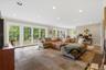 Huge walk-out lower level Recreation Room with wall of French doors/windows, tiled floors and recessed lights.