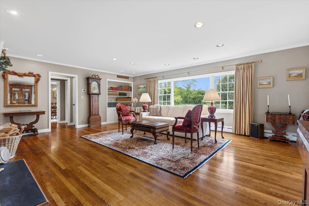 Alternate view of the Living Room with more built-in shelving & a view towards the Dining Room.